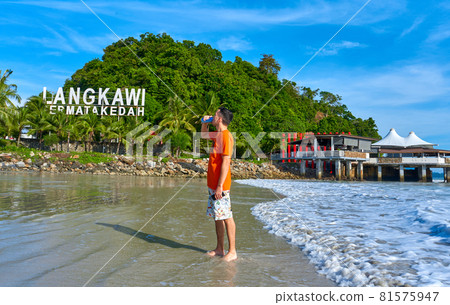 happy tourist guy on the central beach in Langkawi tropical island 81575947