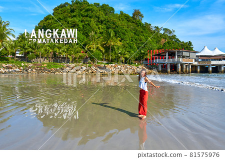 happy tourist woman enjoy travel on the central beach in Langkawi tropical island happy tourist woman enjoy travel on the central beach in Langkawi tropical island 81575976