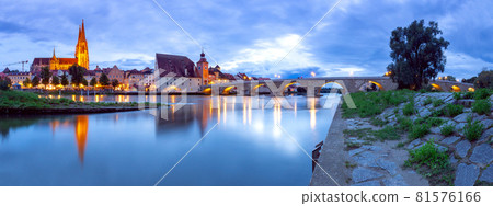 Regensburg. Old stone bridge over the Danube river at night light. 81576166