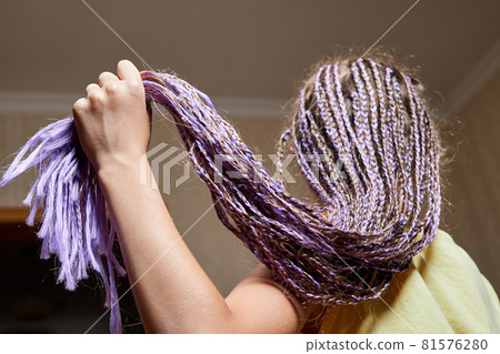 African style hairstyles, many braids braided girl. Close-up, selective focus African style hairstyles, many braids braided girl. Close-up, selective focus 81576280