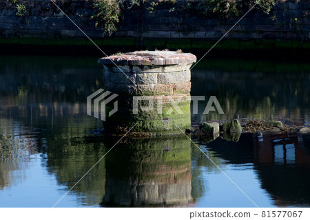 Old Dilapidated Bridge Pier in a River Old Dilapidated Bridge Pier in a River 81577067