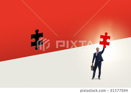 Businessman putting missing jigsaw puzzle piece Businessman putting missing jigsaw puzzle piece 81577894