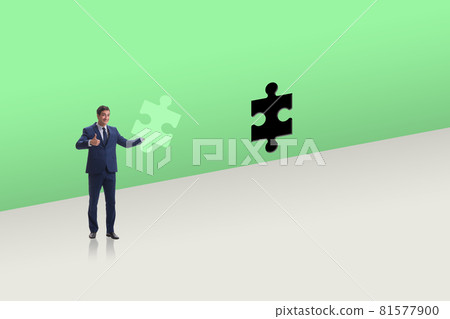 Businessman putting missing jigsaw puzzle piece Businessman putting missing jigsaw puzzle piece 81577900
