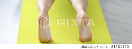 Young sportive woman doing push-ups on mat at home 81581120