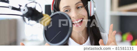 Portrait young woman recording podcast in studio. 81581131