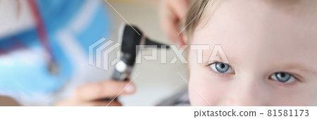 Doctor examining ear with otoscope for little smiling girl Doctor examining ear with otoscope for little smiling girl 81581173