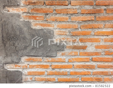 Orange brick wall with cement paving wall with copy space.Weathered stained old stone brick wall. wall texture and background. Orange brick wall with cement paving wall with copy space.Weathered stained old stone brick wall. wall texture and background. 81582322