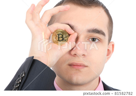Man keeps the eye instead two golden cryptocurrency bitcoin in hands 81582782