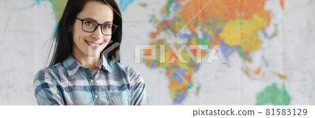 Woman teacher with glasses standing on background of world map 81583129