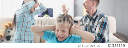 Little girl covering her ears with her hands against background of swearing parents at home 81583139