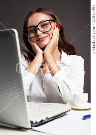 Beautiful girl in glasses. smiling girl with computer 81583495
