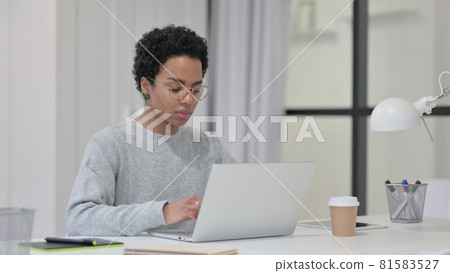 African Woman Working on Laptop in Office African Woman Working on Laptop in Office 81583527