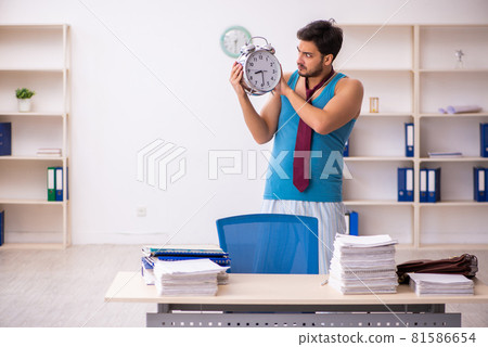Young male employee coming to work straight from bed 81586654