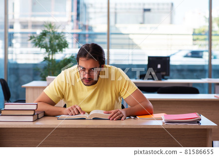 Young male student preparing for exams in the classroom 81586655