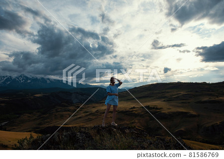 Woman in blue dress in summer Altai mountains Woman in blue dress in summer Altai mountains 81586769
