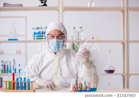Young male chemist working at the lab during pandemic Young male chemist working at the lab during pandemic 81587003