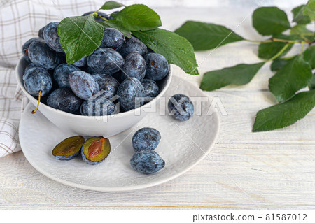 Plums on a light background. Harvesting the autumn harvest. Making jam and sauce. Still life. Plums on a light background. Harvesting the autumn harvest. Making jam and sauce. Still life. 81587012