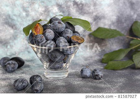 Plums on a light background. Harvesting the autumn harvest. Making jam and sauce. Still life. Plums on a light background. Harvesting the autumn harvest. Making jam and sauce. Still life. 81587027