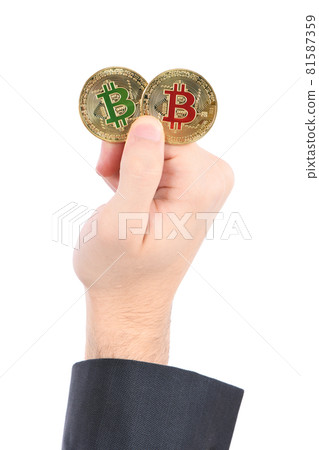 Man's hand holding golden Bitcoin on white background. 81587359