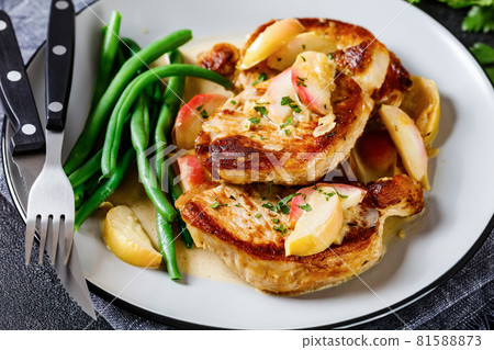 pork chops in apple cider cream sauce on a plate pork chops in apple cider cream sauce on a plate 81588873