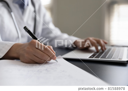 Close up young female gp doctor handwriting notes. Close up young female gp doctor handwriting notes. 81588978