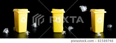 Trash bin set. Yellow dustbin for recycle plastic, paper and glass can trash isolated on black background. Container for disposal garbage waste and save environment. Trash bin set. Yellow dustbin for recycle plastic, paper and glass can trash isolated on black background. Container for disposal garbage waste and save environment. 81589748