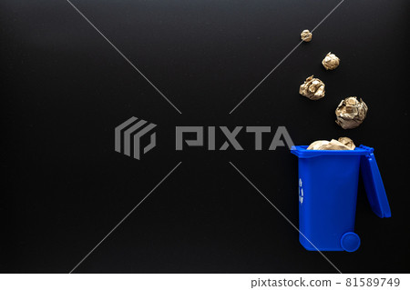 Recycled paper. Blue dustbin for recycle plastic and glass can trash on black background. Bin container for disposal garbage waste and save environment. Copy space. 81589749