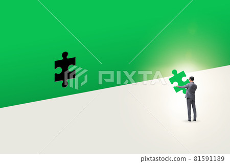 Businessman putting missing jigsaw puzzle piece 81591189