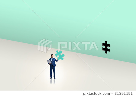 Businessman putting missing jigsaw puzzle piece Businessman putting missing jigsaw puzzle piece 81591191