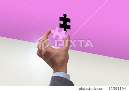 Businessman putting missing jigsaw puzzle piece Businessman putting missing jigsaw puzzle piece 81591194
