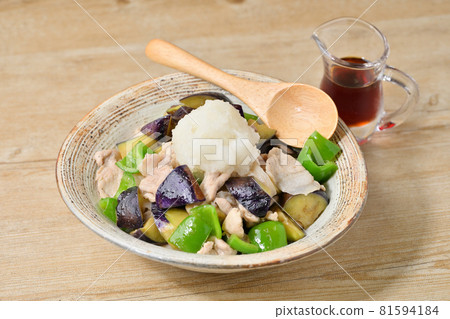 Stir-fried eggplant and peppers with pork, grated radish and ponzu sauce. 81594184