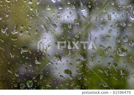 Water drops in the rain on the house window. Weather conditions Water drops in the rain on the house window. Weather conditions 81596470