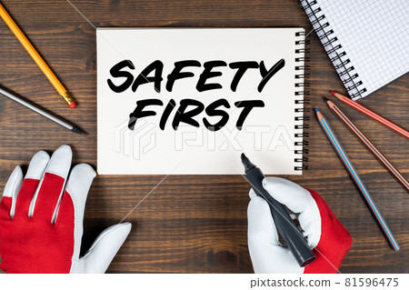 Safety First. Notebook and office supplies on wood background 81596475