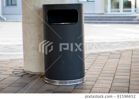 Modern rubbish bin on a street in a public place. Warm and sunny day 81596652