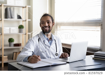 Distracted young african doctor looking in distance. 81597029