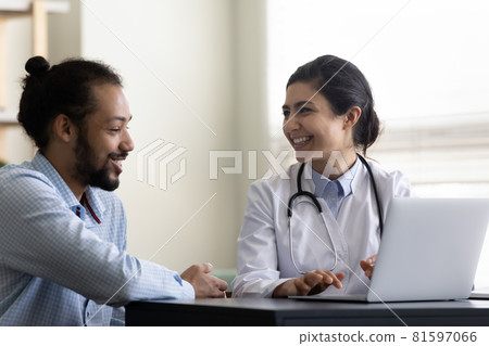 Happy millennial african american patient talking with indian doctor. 81597066