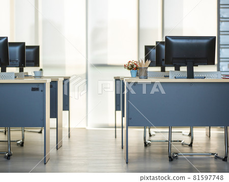 Background photo of modern indoor interior working space, office or workplace with nobody and row of computers on wooden desks or tables. Technology and Business Concept. 81597748