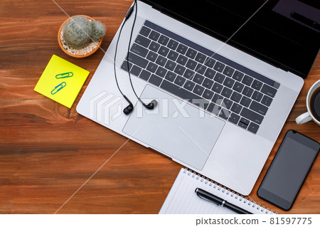 Top view or topdown shot of laptop notebook computer with blank screen smartphone on wood background with copy space. Business idea and creative working concept 81597775