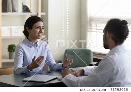 Smiling indian patient talking with african doctor. 81598016