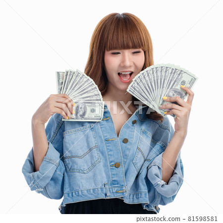 Asian woman smiles and holding American banknotes.. Asian woman smiles and holding American banknotes.. 81598581