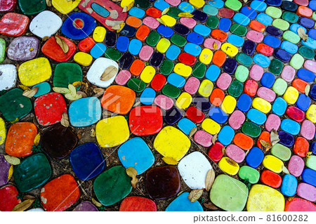 Top view on pieces of multicolored ceramic tiles decorated in garden. Old pavement of tiles textured. Street mosaic cobblestone sidewalk. Abstract,background and pattern of ceramic tile on the floor. 81600282