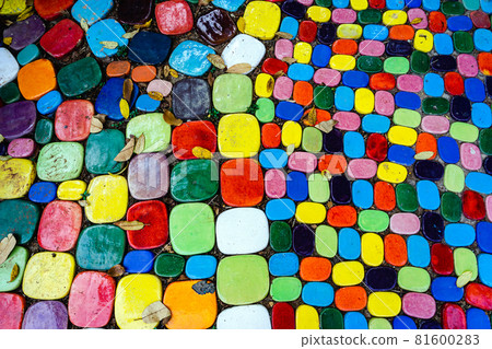 Top view on pieces of multicolored ceramic tiles decorated in garden. Old pavement of tiles textured. Street mosaic cobblestone sidewalk. Abstract,background and pattern of ceramic tile on the floor. Top view on pieces of multicolored ceramic tiles decorated in garden. Old pavement of tiles textured. Street mosaic cobblestone sidewalk. Abstract,background and pattern of ceramic tile on the floor. 81600283