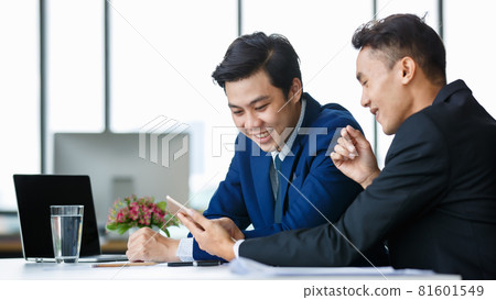 Cheerful ethnic businessmen discussing project in office Cheerful ethnic businessmen discussing project in office 81601549