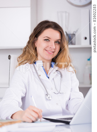 Nurse in uniform filling up documents 81602283