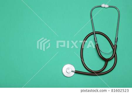 Medical background. Stethoscope on a clear green background. Pharmacology, clinic, health and disease treatment concept Medical background. Stethoscope on a clear green background. Pharmacology, clinic, health and disease treatment concept 81602523