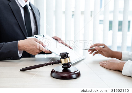 A male lawyer or a judge counseling clients about judicial justice and prosecution with scales, judges gavel, legal documents legal services concept A male lawyer or a judge counseling clients about judicial justice and prosecution with scales, judges gavel, legal documents legal services concept 81602550