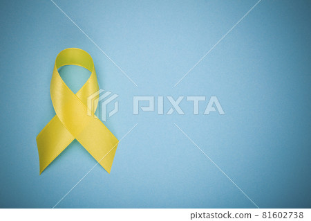 Yellow ribbon, Childhood Cancer Awareness Month. Cancer or suicide prevention ribbon. Children healthcare background. Copy space Yellow ribbon, Childhood Cancer Awareness Month. Cancer or suicide prevention ribbon. Children healthcare background. Copy space 81602738