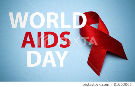 AIDS ribbon on a blue background with text. Red ribbon, symbol of World AIDS Day or HIV Awareness Month and concept of healhcare 81603065