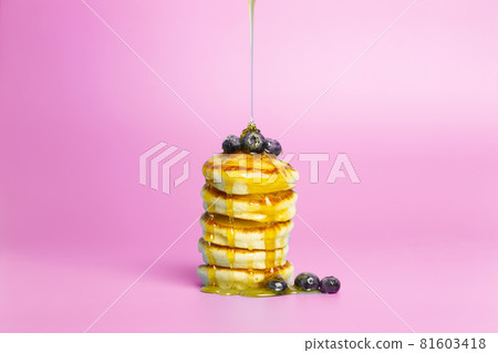 Pancakes with berries on a pink banner background. Lush delicious pancakes with blueberries and syrup for brunch on a minimal colored background. Beautiful bright food photo Pancakes with berries on a pink banner background. Lush delicious pancakes with blueberries and syrup for brunch on a minimal colored background. Beautiful bright food photo 81603418