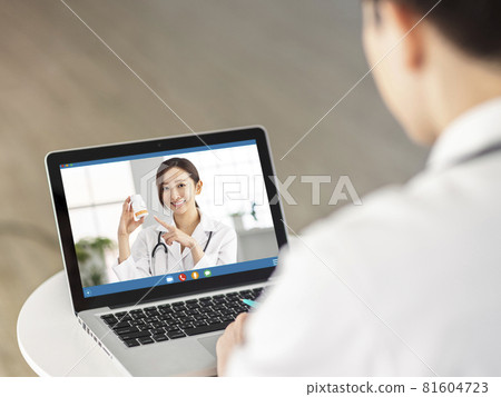 Back view of doctor making video call colleague Back view of doctor making video call colleague 81604723